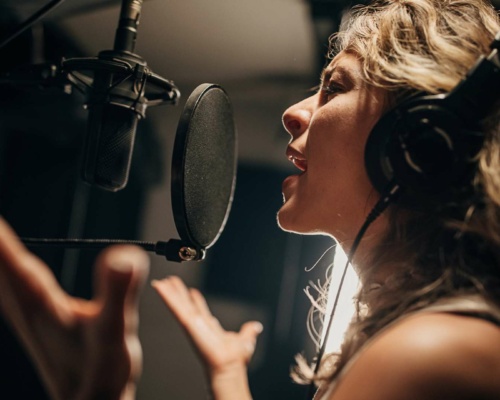 woman-voiceover-artist-in-recording-studio